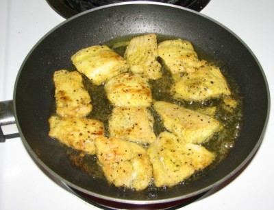 Fish being shallow fried for fish molee